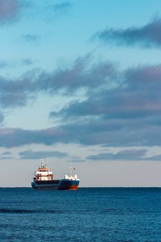 Blue bulk carrier sailing in still water