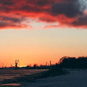 Hot winter sunrise over the cargo port in Riga