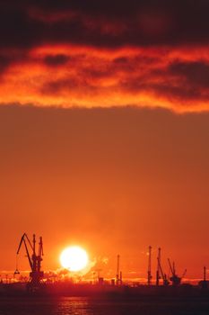 Hot winter sunrise over the cargo port in Riga