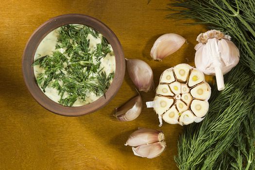 Garlic dip sauce with fresh herbs of dill