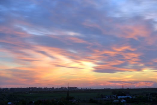 Dramatic sunset over city in spring time