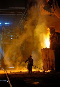 steel worker near oven  inside of steel plant