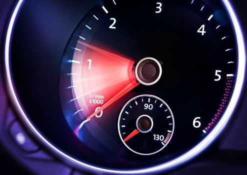 illuminated dashboard with tachometer of car