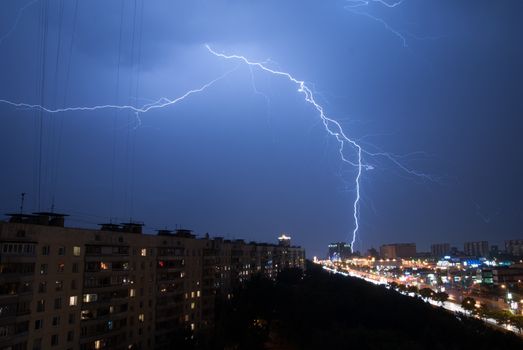 Bright Lightning in the sky of the Moscow city at night .