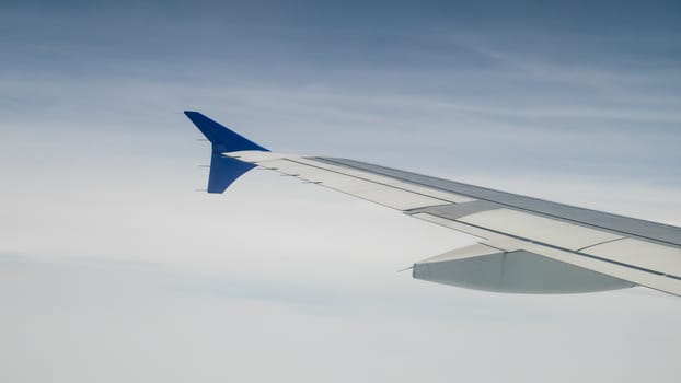 The airplane wing on the beautiful cloudy and sky.