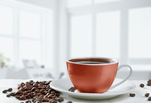red coffee cup and beans on white background