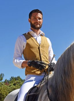 riding man and his stallion in a training of dressage