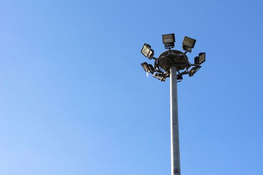 Spotlights electric poles with blue sky  for background