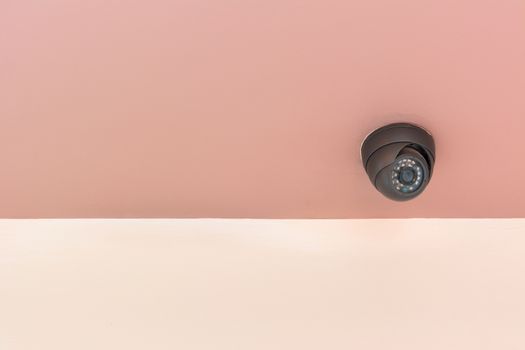 Modern security camera on the indoor concrete wall