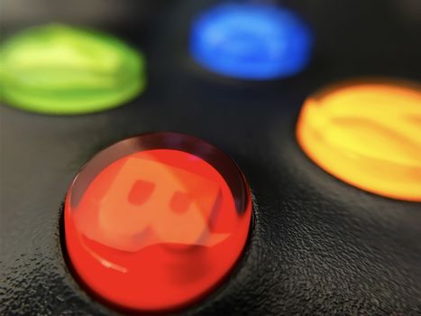 Illuminated buttons of a console gaming controller.