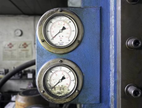 Dials of a pressure gauge from an hydraulic press machine.