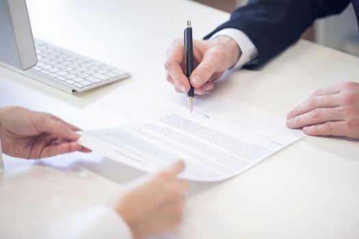 Human hands working with documents, signing contract at the desk closeup