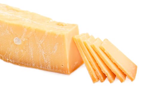 Several thin slices of the Dutch hard cheese Beemster on a dark glass saucer and piece of the same cheese beside on a light background
