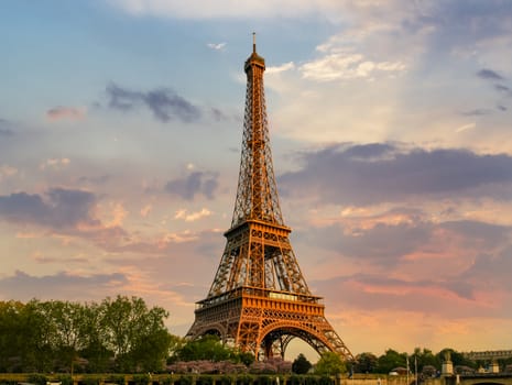 Eiffel Tower against the sky with clouds in springtime on the sunset in Paris, France
