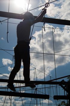 Silhouette of the person in the Rope town against the background of the sky