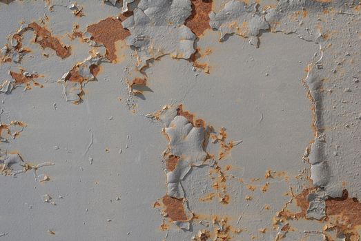 fragment of an iron surface is covered old paint, which has long been under the influence of different climatic conditions