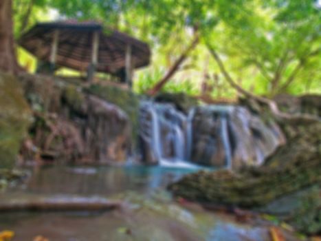 Abstract blurred waterside pavilion with waterfall.