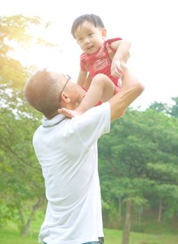 Asian father playing with baby boy