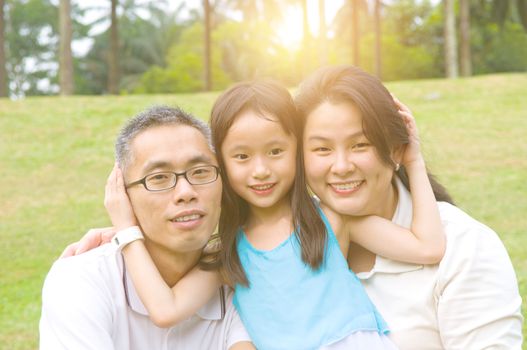 Outdoor portrait of asian family