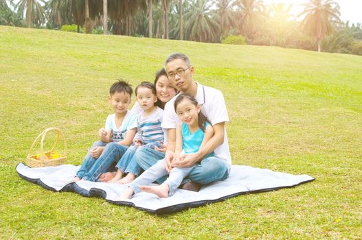 Outdoor portrait of asian family