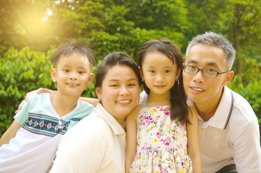 Outdoor portrait of asian family