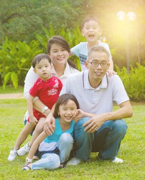 Outdoor portrait of happy asian family