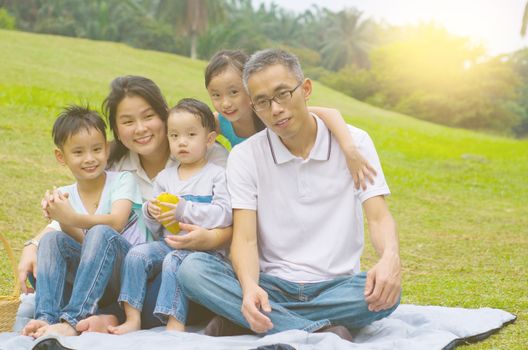 Outdoor portrait of asian family