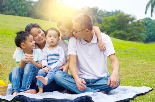 Outdoor portrait of asian family