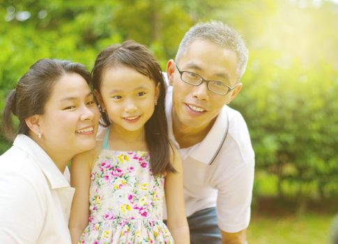 Outdoor portrait of asian family