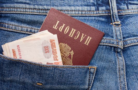 Russian rouble bills and passport in the back jeans pocket close up