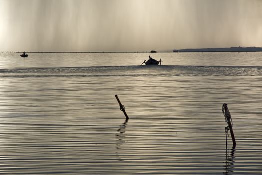 Sunset in the lagoon, where fishermen return to the approach of the impending storm. Dawning. Mediterranean islands.