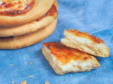 Traditional russian pasties Shanga - opened circle pie with cottage cheese. Close up view of carols cheesecake with cottage cheese.