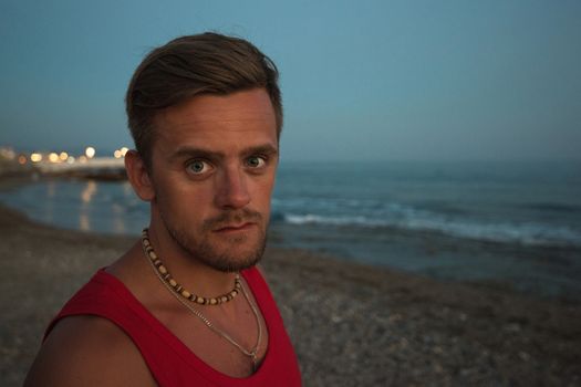 Young man at the evening sea, on the beach at Alania, Turkey