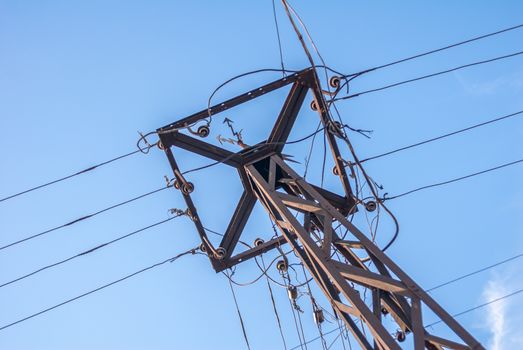 old electric pole in a sunny day against the blue sky