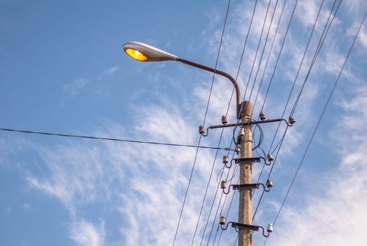 vintage electric pole in a sunny day against the blue sky