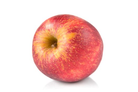 Beautiful ripe juicy red apple, lying on its side, isolated on a white background