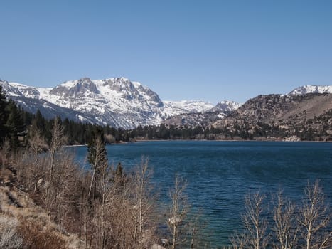 Beautiful lake, snow mountain and pine tree with blue sky in California, USA