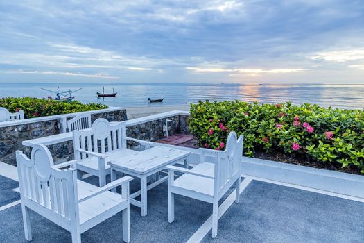 Table and chairs set on balcony near the beach