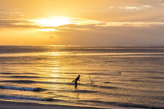 Fisherman throwing net , fishing in the morning on the beach