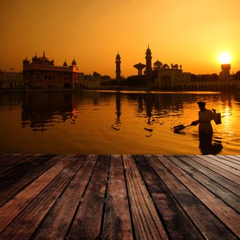 Cleaning the pool of the Golden Temple during sunset, Amritsar, India.