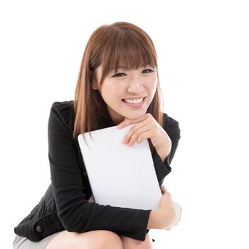 Young Asian female holding digital computer tablet and smiling, isolated on white background.
