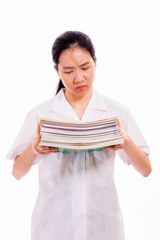 Chinese high school girl in uniform holding a stack of books, looking unhappy