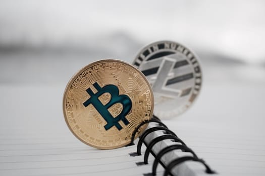 Cryptocurrency physical gold bitcoin and silver litecoin coins.