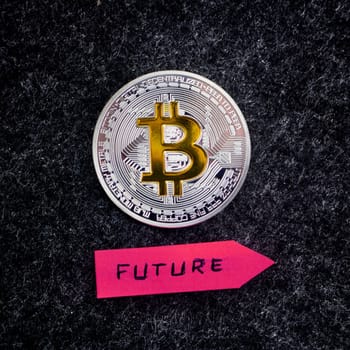 Cryptocurrency physical silver bitcoin coin and pink future arrow