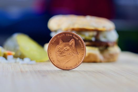 Cryptocurrency physical brass dogecoin money and burger food