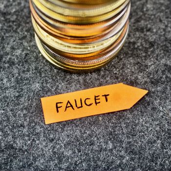Orange arrow with faucet inscription near silver and gold coins.