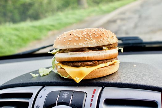 Tasty cheeseburger on the car