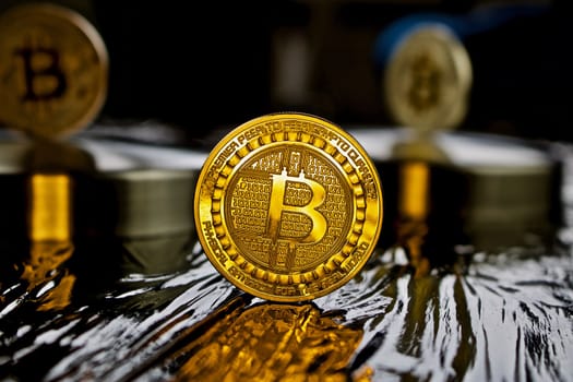 Cryptocurrency physical gold bitcoin coin in black scene