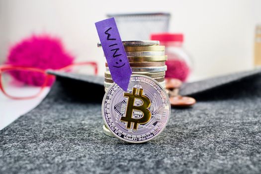 Digital currency silver bitcoin coin with yellow "b" sign.