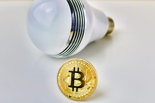 Physical bitcoin coin and big bulb